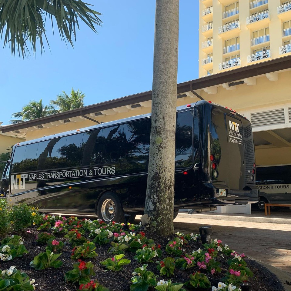 A NT&T bus outside of a hotel
