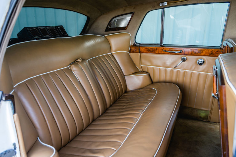 Brown leather interior of the old white car for weddings