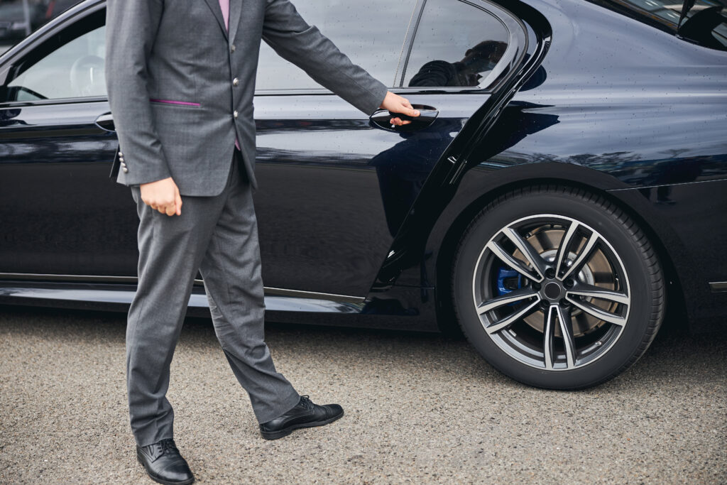 Cropped,Photo,Of,A,Driver,In,A,Stylish,Suit,Opening